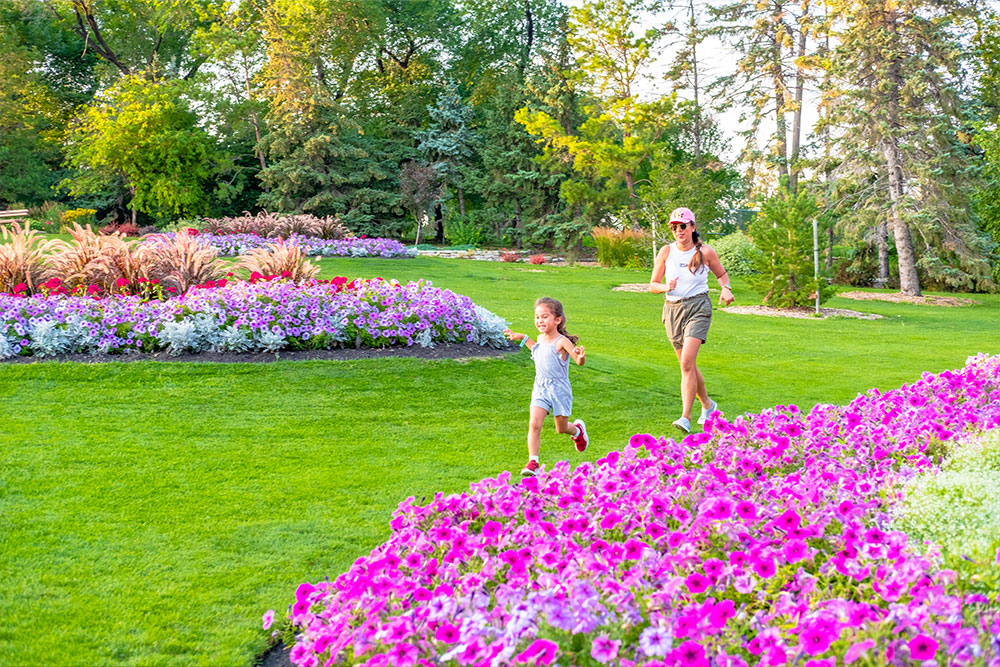 Mother and child walking in flower garden